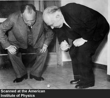 Wolfgang Pauli ve Niels Bohr bir topacın hareketini gözlemliyor.